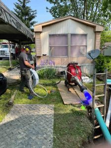 technician working on pipe lining in front of house Columbus, OH